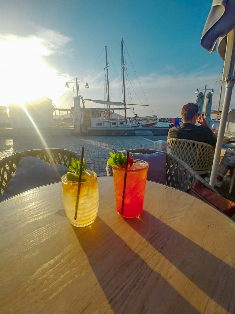 craft cocktails at sunset in Naoussa, Paros in harbor at sunset