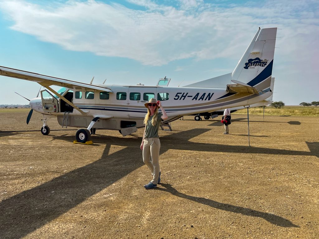 what to wear on safari for women, Safari outfit for women: olive green shirt, khaki pants, trail runners, and sun hat